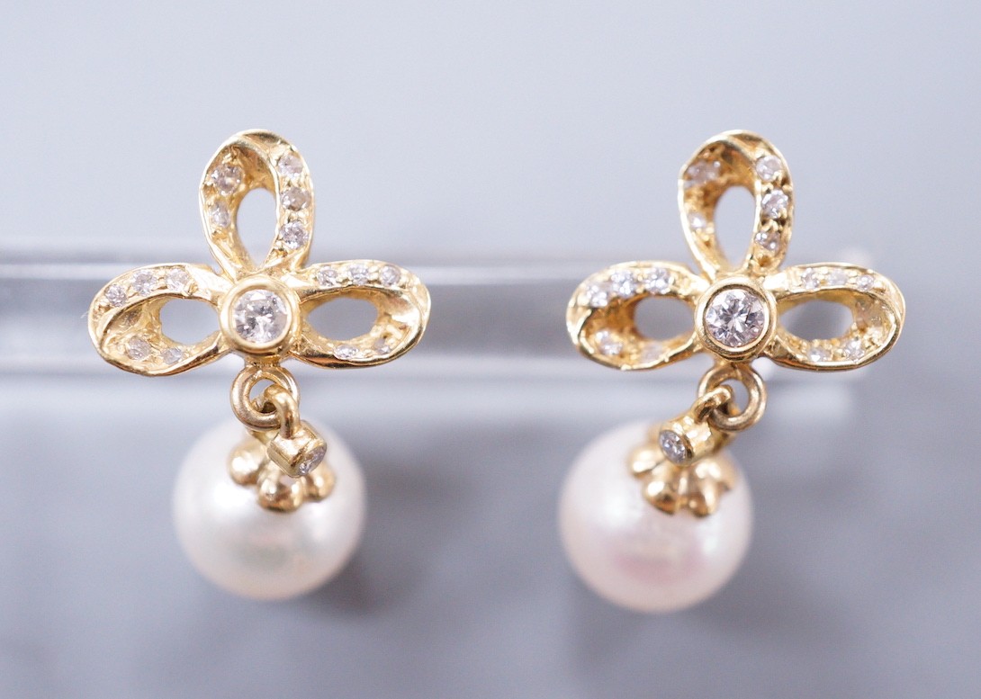 A modern pair of 18k yellow metal, cultured pearl and diamond cluster set drop earrings, 21mm, gross weight 4.3 grams.